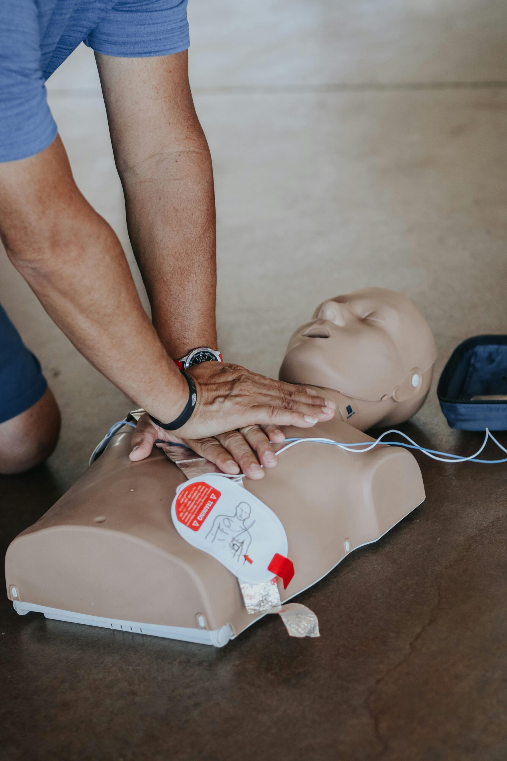 Man performing CPR on mannikin